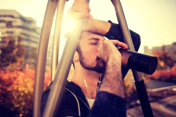 man drinking from stainless steel water bottle